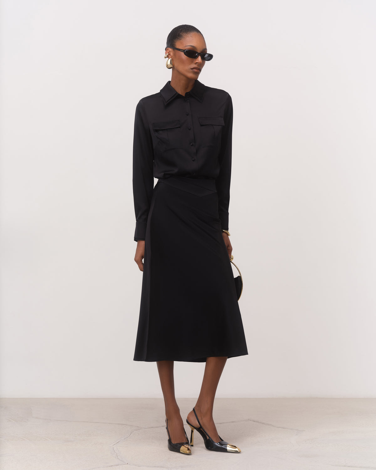 Women's black silk midi skirt with soft A-line flare, full-length front view