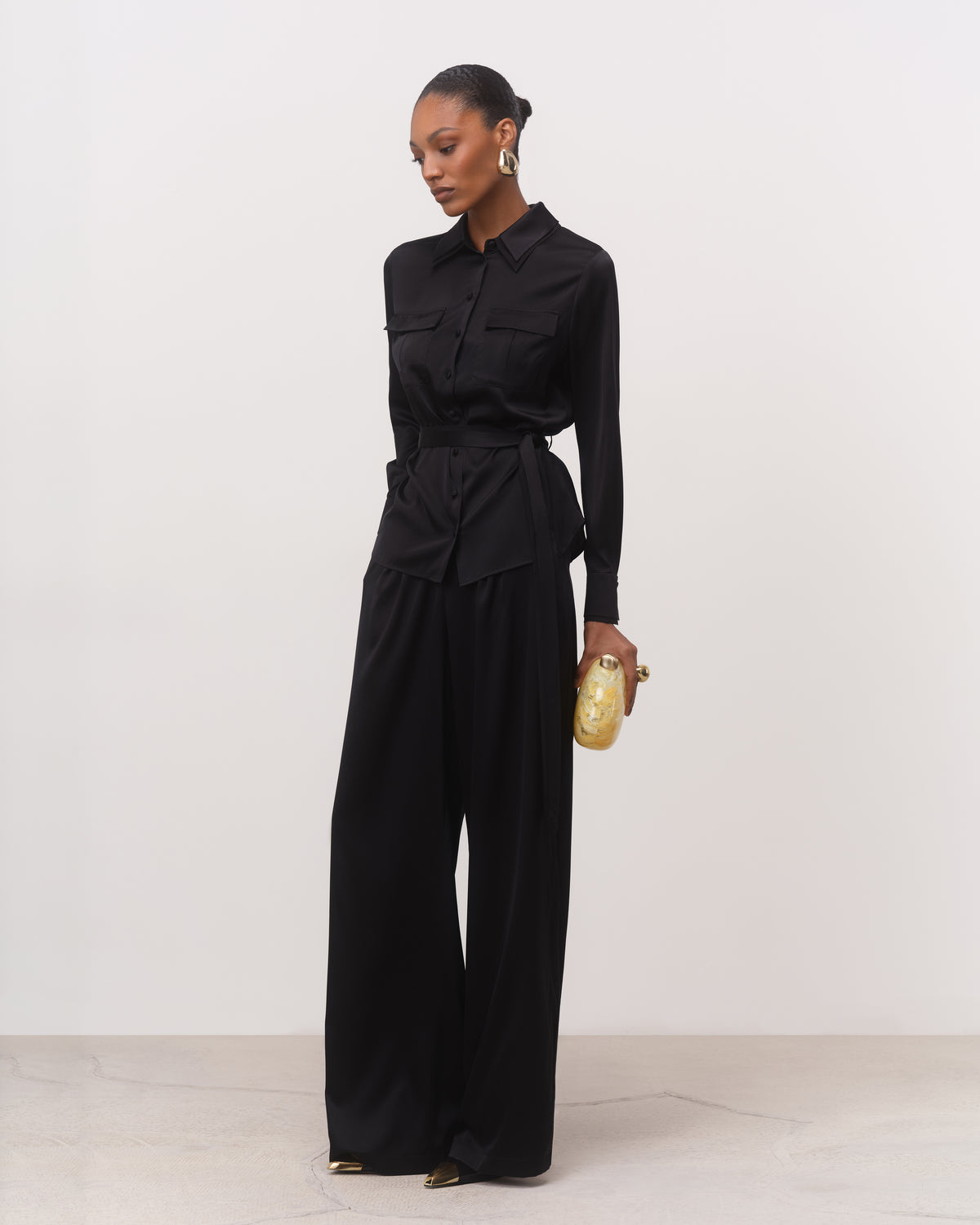 Black silk belted shirt with palazzo pants, three-quarter view
