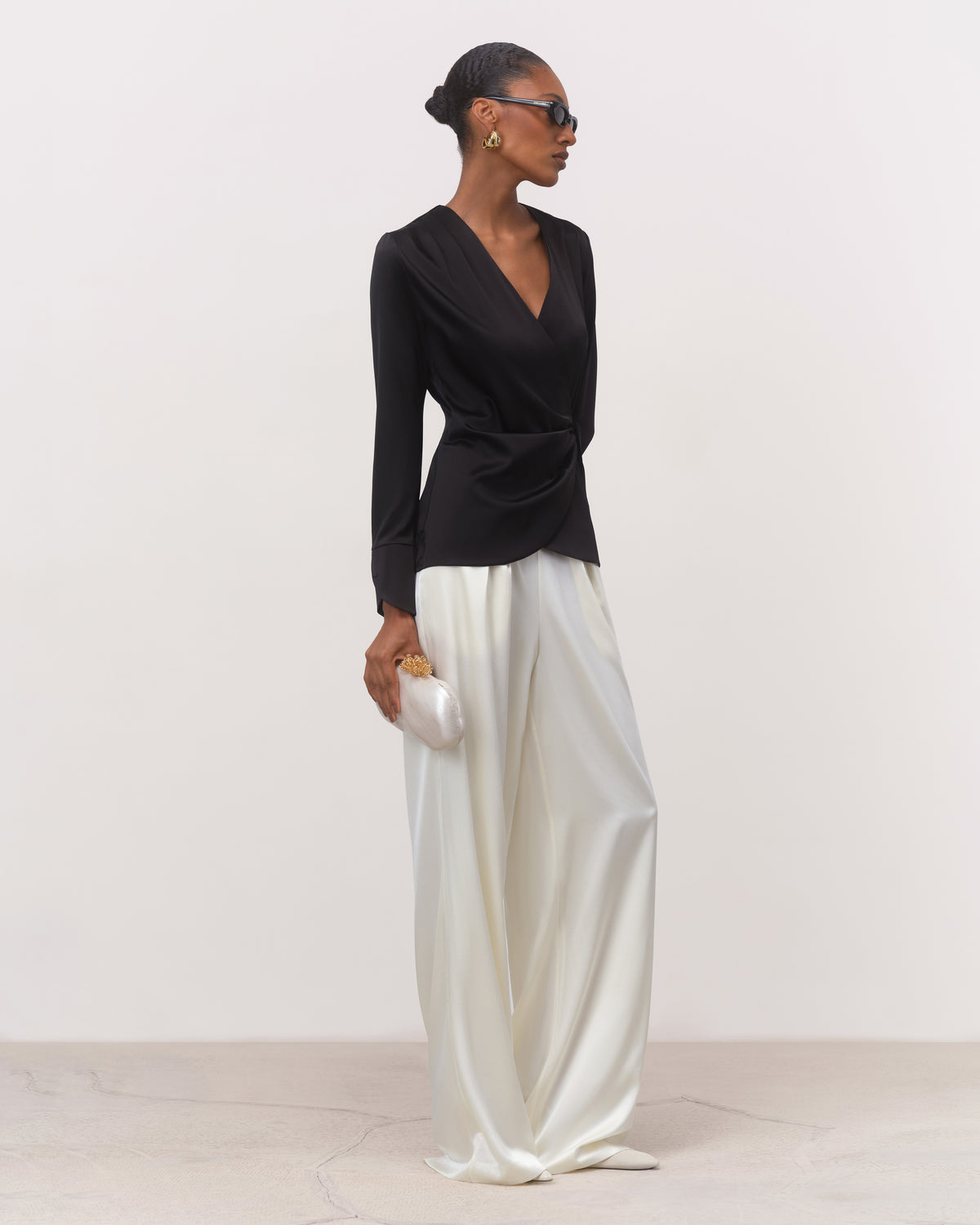 Women's black mulberry silk crossover blouse with long waist ties, three-quarter view