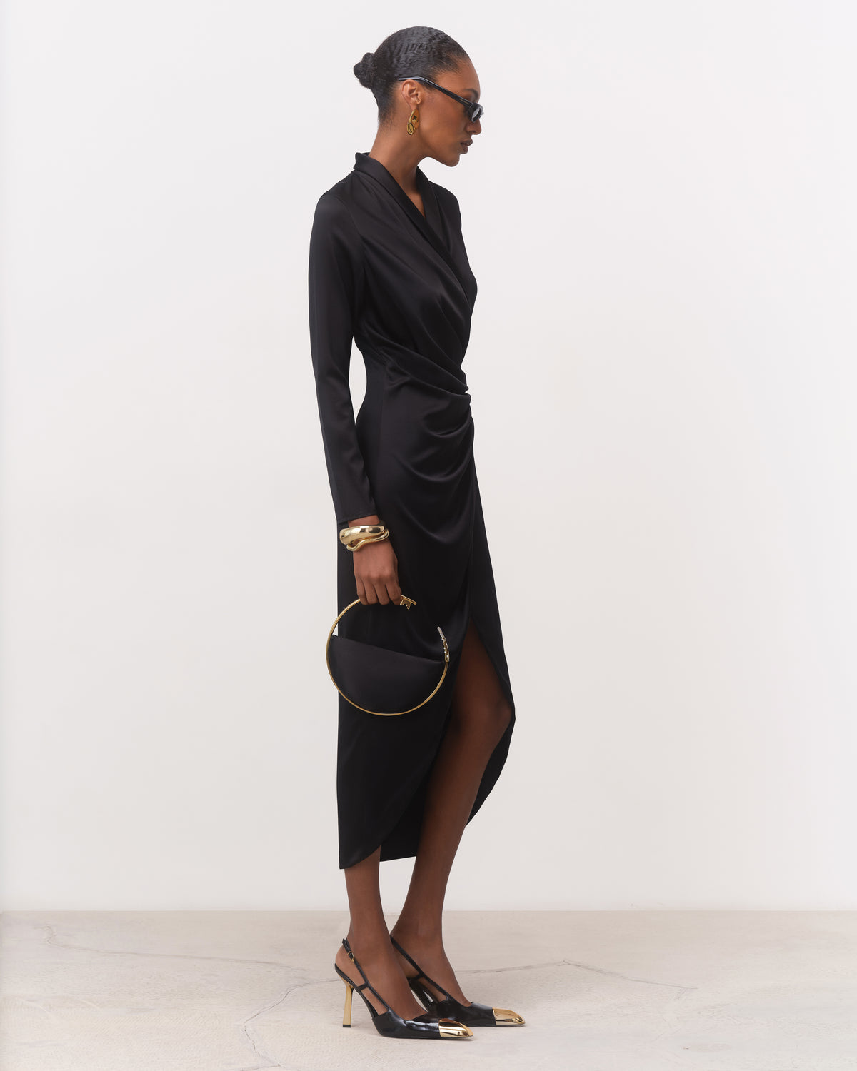 Side view of black robe-style silk wrap midi dress with front slit