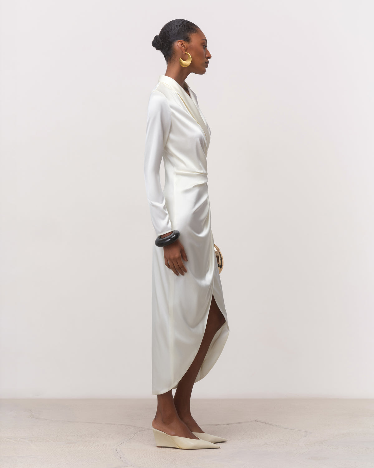 Side view of pearl off-white robe-style silk wrap dress with front-slit hem