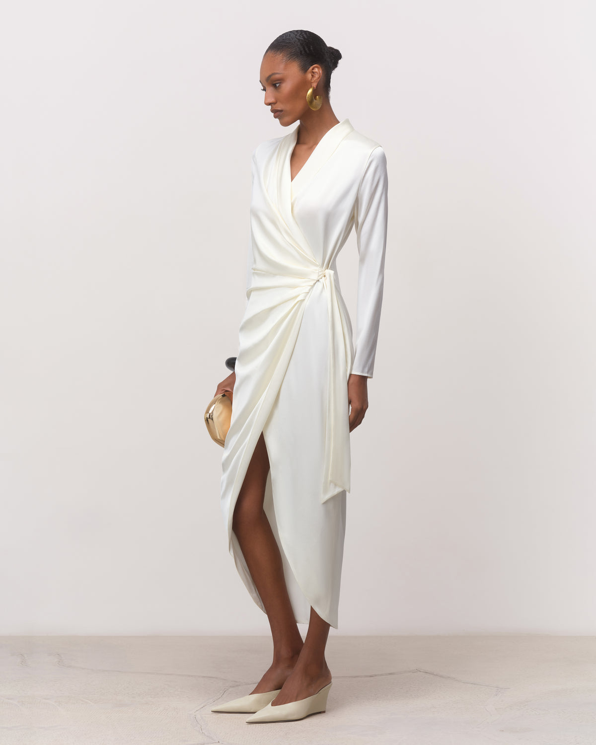 Long sleeve white silk wrap midi dress with draped skirt, three-quarter view