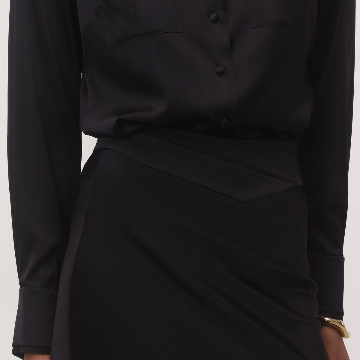 Women's black silk midi skirt with soft A-line flare, full-length close up view