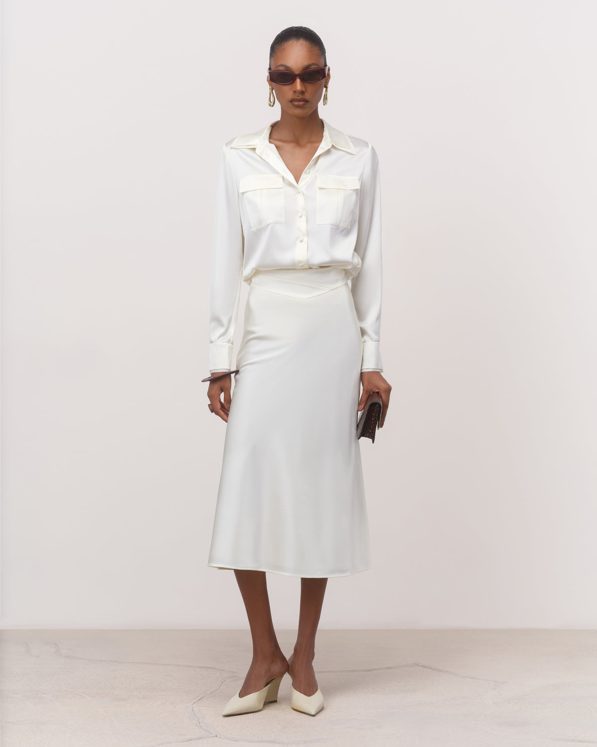 Women's white silk midi skirt with fluid A-line sweep, full-length front view